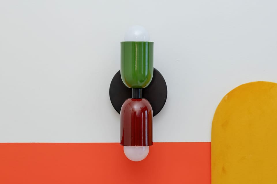 A close-up of colorful wall decorations in green, red, and yellow.