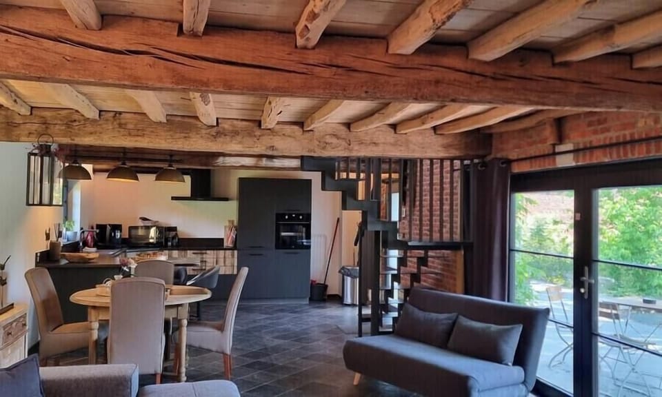 Bright living room overlooking the kitchen, with a pleasant view of the terrace.