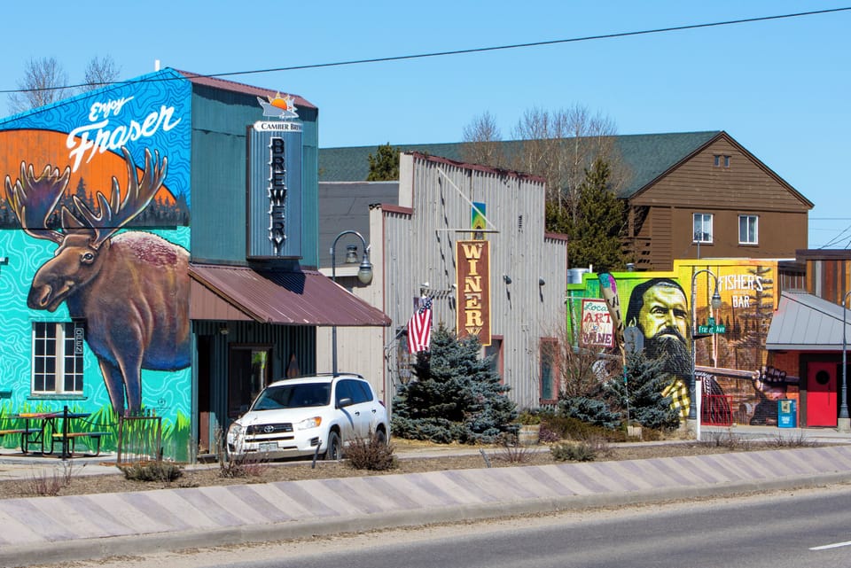 A vibrant collection of local businesses and colorful murals line the main street, showcasing the artistic character and welcoming spirit of this charming neighborhood.