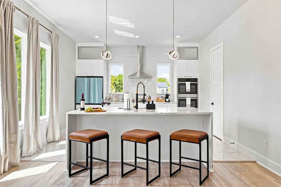 Whip up delicious meals amidst sleek design and bright, inviting spaces!