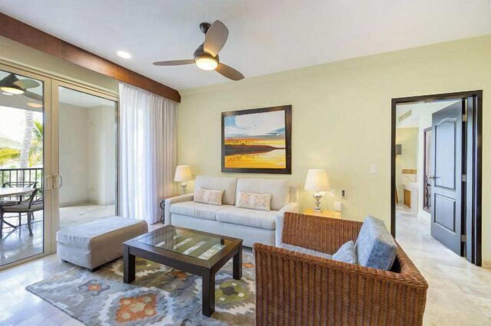 Bright coastal living room with balcony access and stylish seating