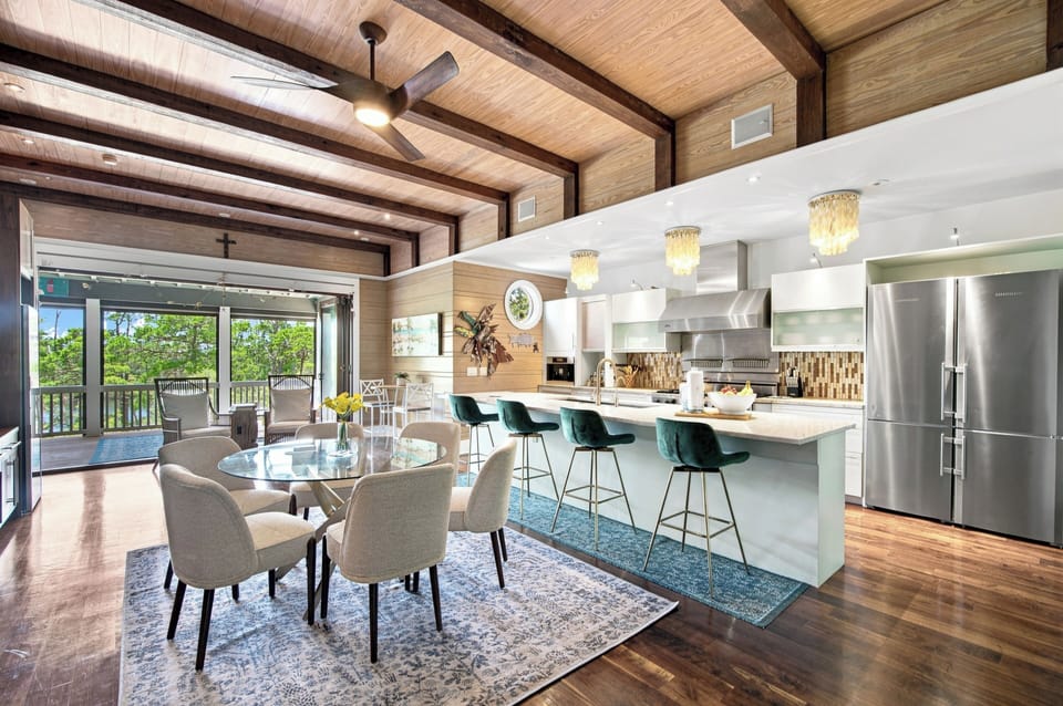 Step into your dream vacation kitchen—soaring wood ceilings, elegant chandeliers, and a chef's island where you can gather with loved ones over morning coffee or evening cocktails.