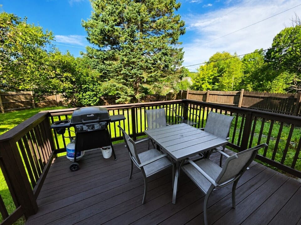 Enjoy outdoor dining and grilling on the private deck overlooking the spacious backyard.