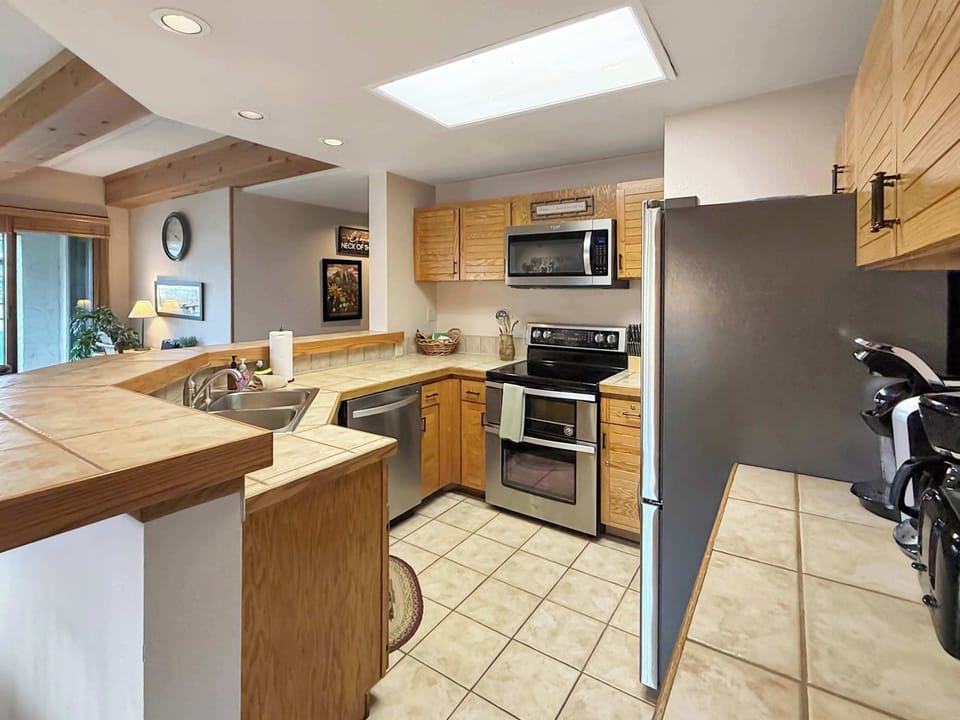 Well appointed full kitchen with bar seating | Listed with @BookTraverse