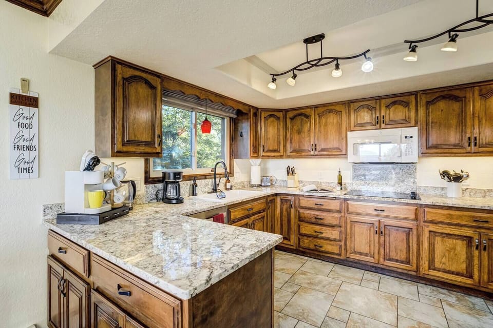The fully-equipped kitchen features granite countertops, stainless steel appliances and ample space to prepare group meals.