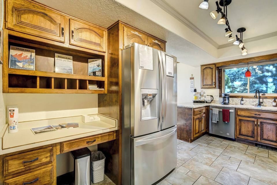 The fully-equipped kitchen features granite countertops, stainless steel appliances and ample space to prepare group meals.