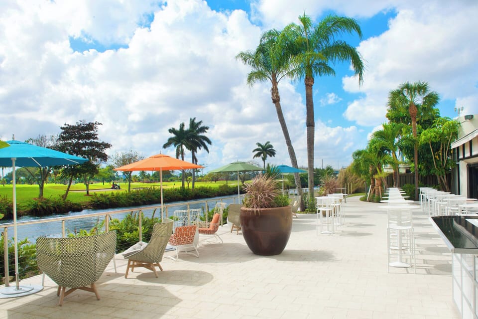 Unwind on the breezy patio with colorful umbrellas and views.
