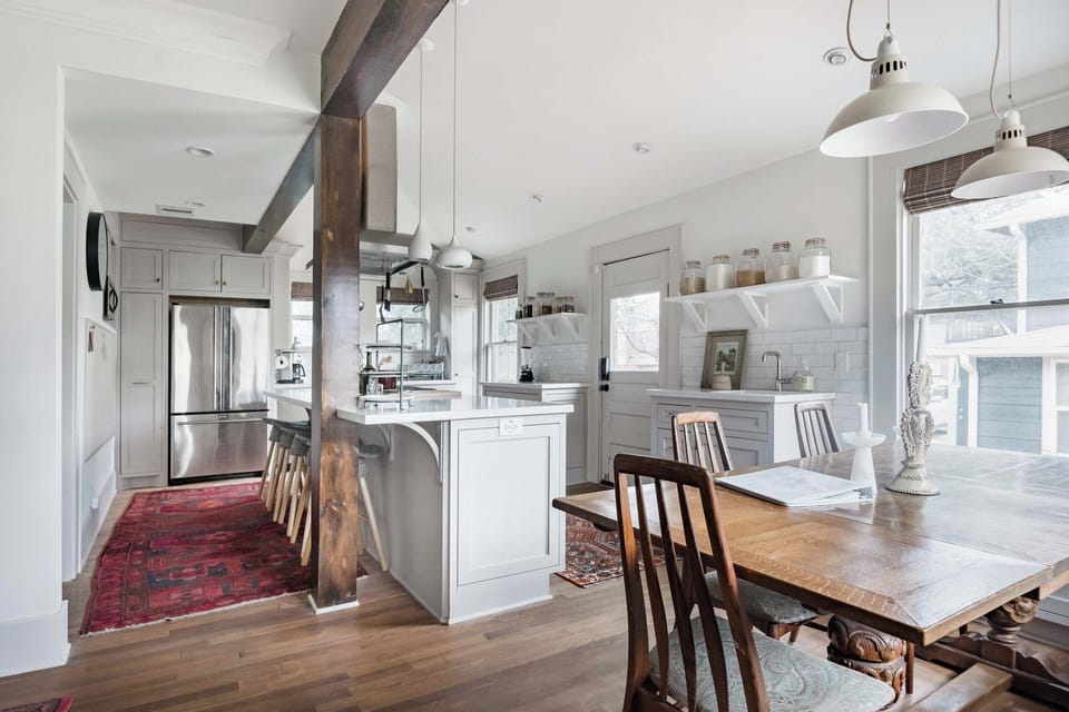 Bright farmhouse kitchen with island seating and sunny dining space