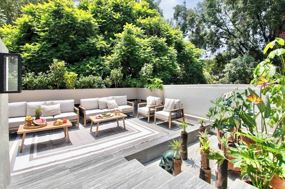 Enjoy a peaceful outdoor retreat surrounded by mature trees and abundant plants. Multiple seating areas make this terrace ideal for groups who want to spread out while enjoying fresh air and a sense of privacy above the city.