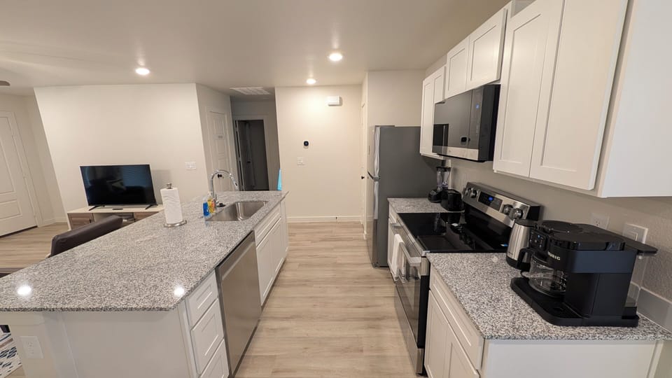 Bright modern kitchen with island, stainless appliances, and open layout