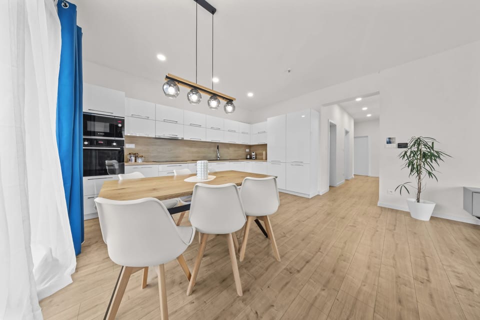 Bright modern kitchen with stylish dining area and airy open layout