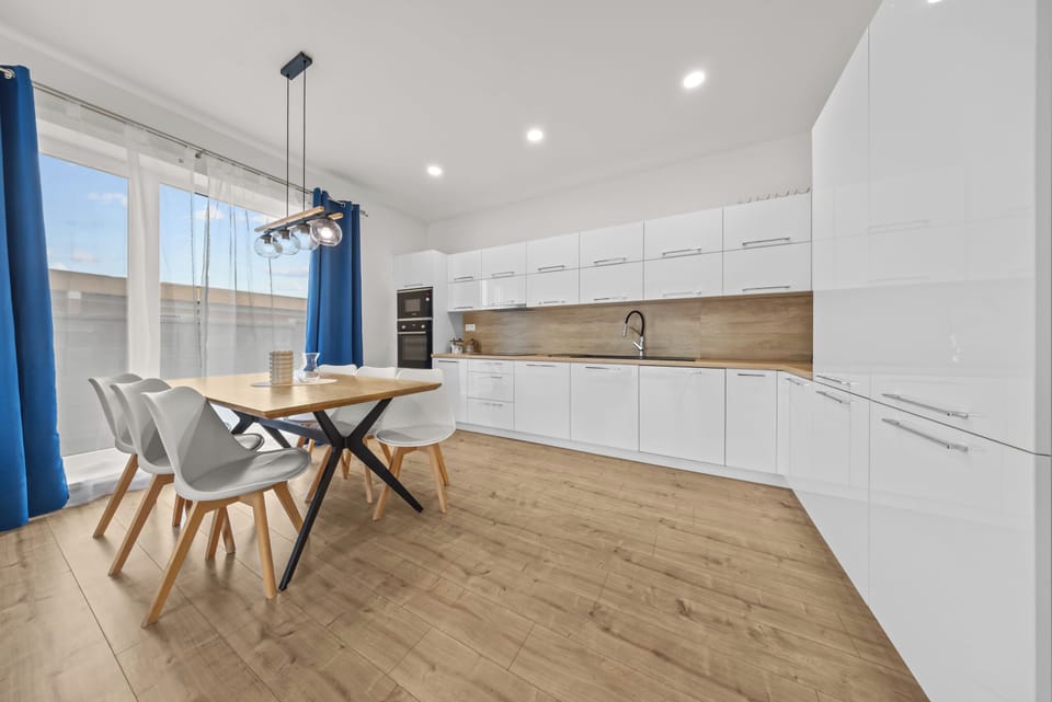 Bright modern kitchen with stylish dining space and natural light