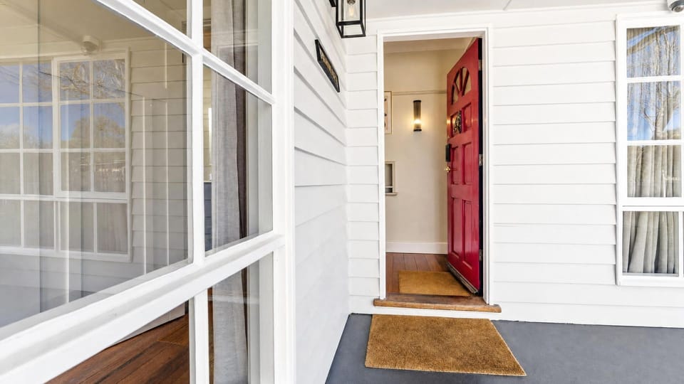 Welcoming front entryway with a vibrant red door.