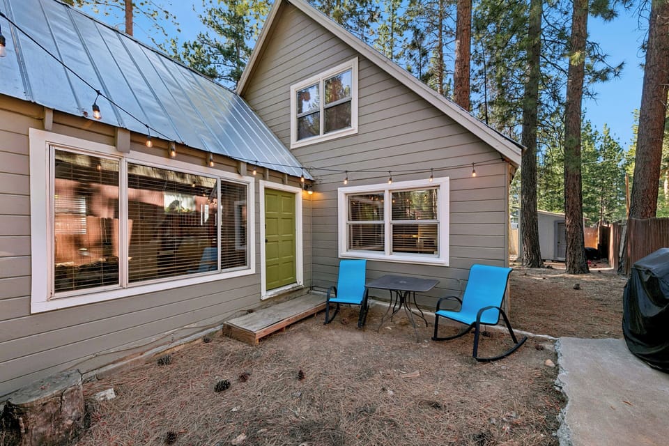 Kick back on the rear patio in vibrant blue rocking chairs, ideal for morning coffee or relaxing in the crisp mountain air.