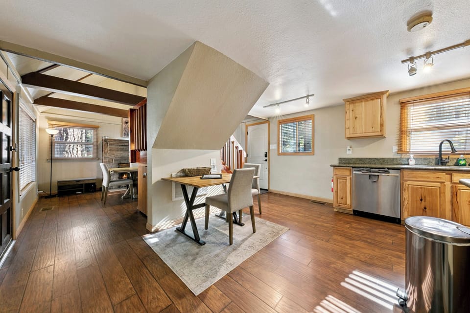 The main level offers a seamless connection between the kitchen and dining areas, featuring rich hardwood-style flooring throughout.