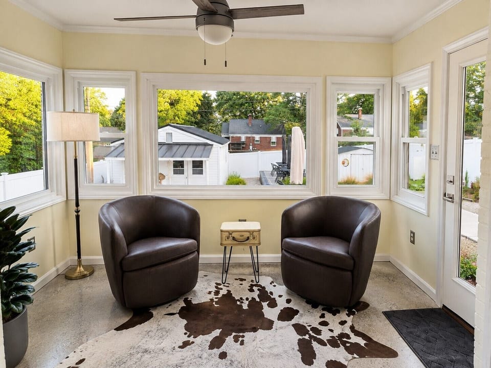 Bright sunroom with cozy seating and peaceful outdoor views
