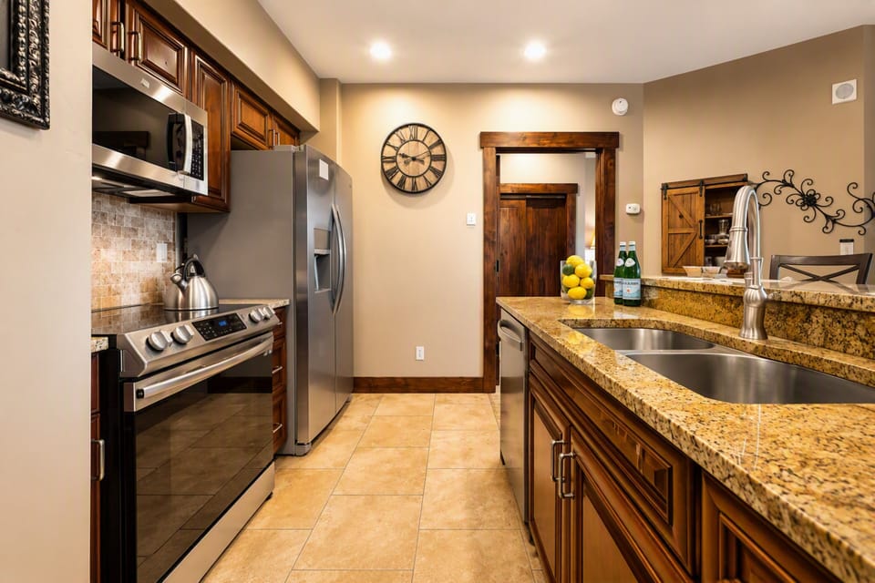 Step into your fully equipped kitchen with granite countertops, stainless steel appliances, and warm wood cabinetry. Everything you need to prepare delicious meals during your mountain getaway.