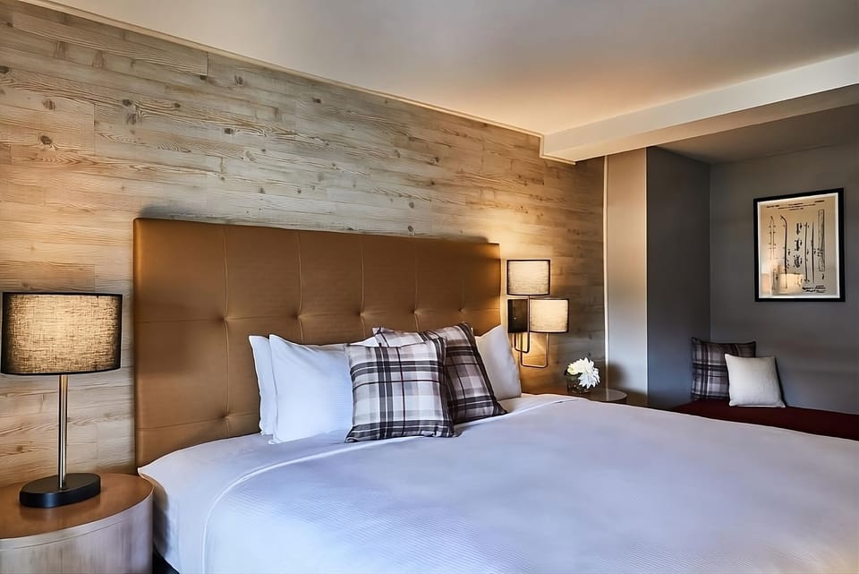 Sink into crisp linens beneath warm, cabin-inspired textures.