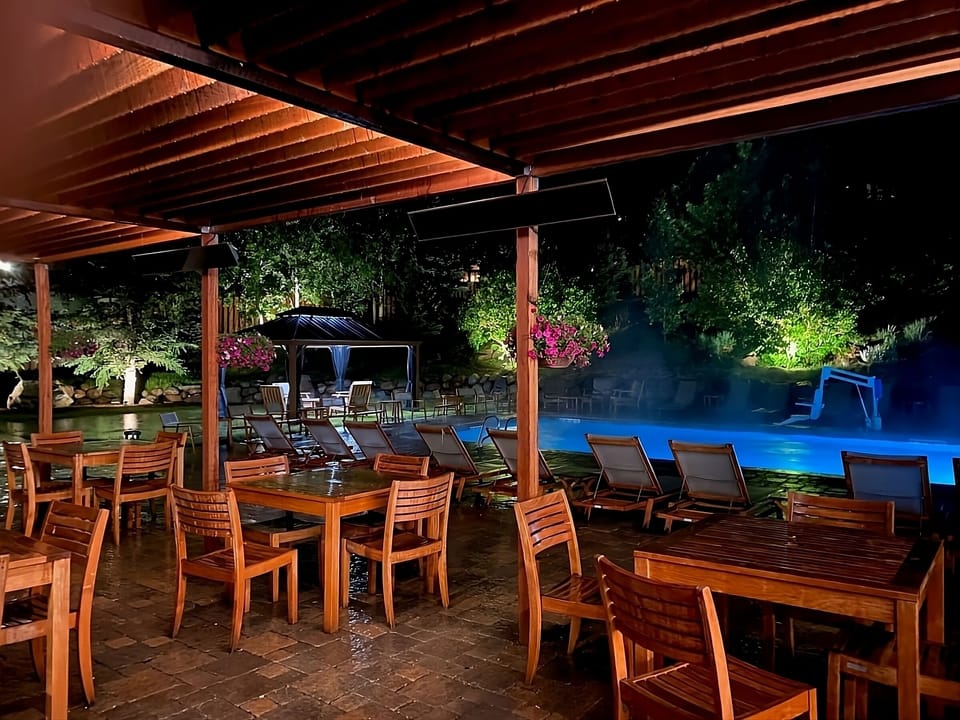 Unwind poolside under warm lights with resort-style evening vibes.