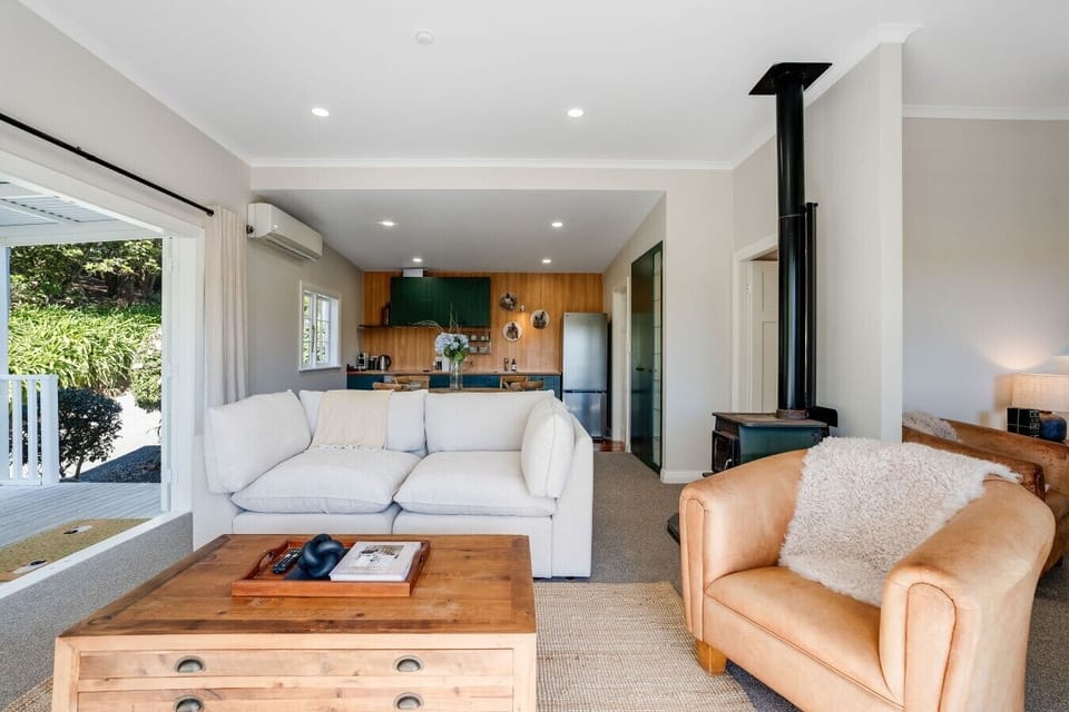 Bright open-plan living in the cottage with a wraparound deck (fireplace is non-operational)