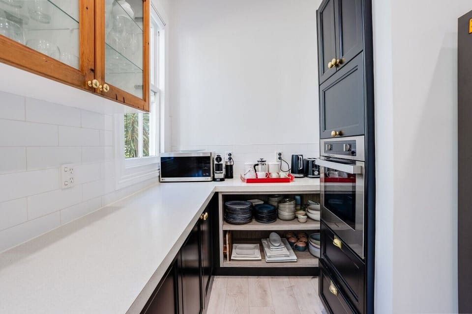 Kitchen nook with a Nespresso machine, French press, toaster and kettle, with Nespresso pods, coffee and tea provided