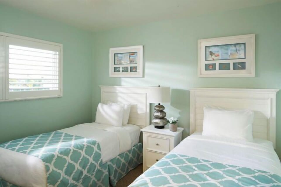 Bright twin bedroom with coastal decor and cheerful natural light