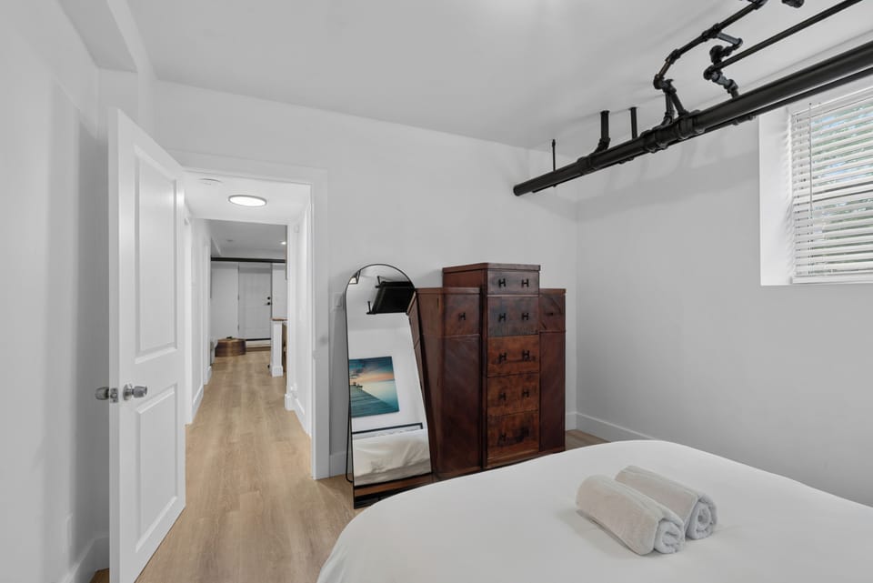Minimalist bedroom with warm wood floors and modern industrial style