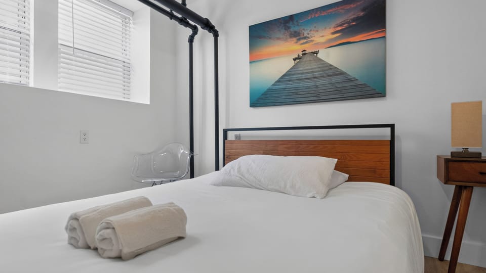 Bright minimalist bedroom with modern touches and serene artwork