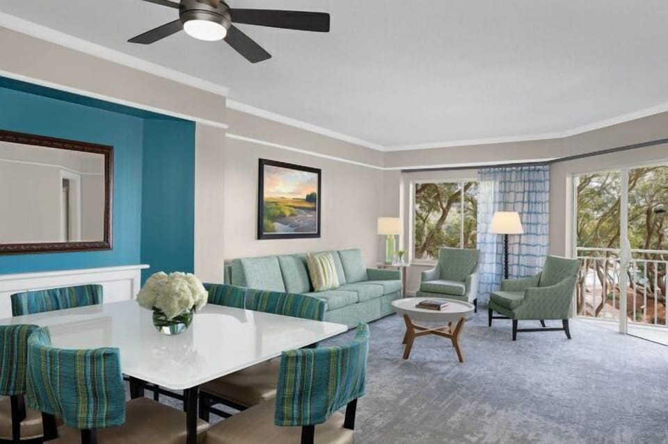 Bright coastal living area with balcony views and open dining space