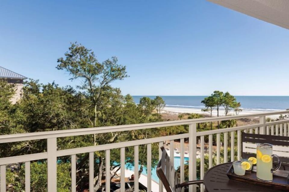 Private balcony with pool views and a beautiful ocean backdrop