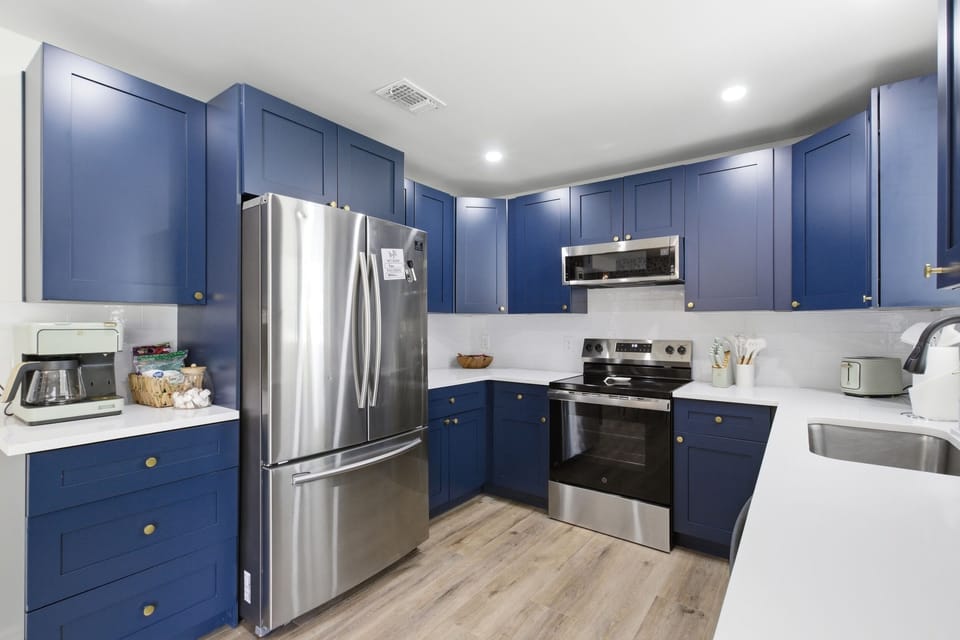 Spacious Kitchen with Samsung Refrigerator, GE Single Oven, Whirlpool Microwave, and bright quartz countertops. Fully stocked for group meals and game-day cookouts.
