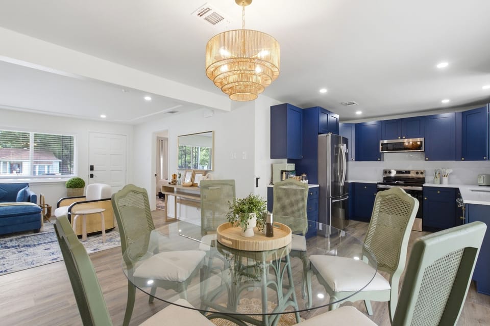Open Dining Room flowing into the Kitchen and Living Room. Dining Table seating for 6, modern chandelier, and easy connection to the rest of the home.