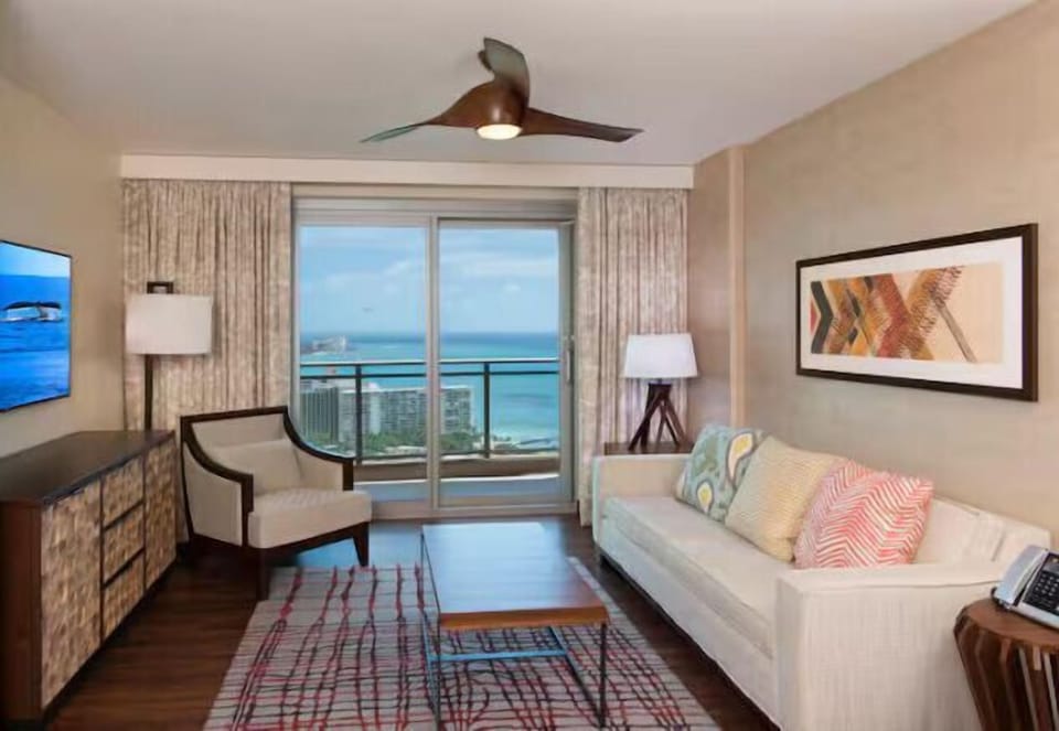 Bright coastal living room with private balcony and stunning ocean views