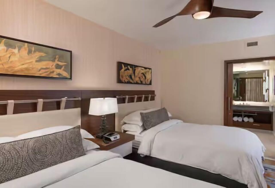 Bright double-queen room with modern decor and a spacious, polished feel