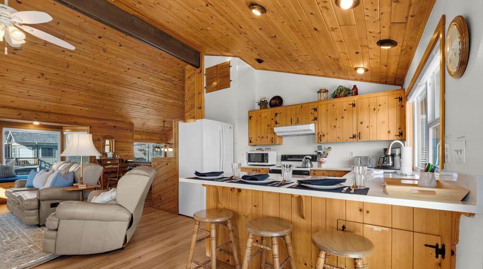 Warm knotty pine surrounds you in this inviting open-plan kitchen where you'll love cooking and gathering.