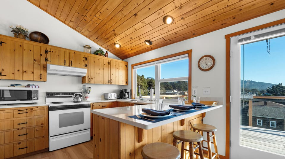 Your bright kitchen features rustic wood cabinets, modern appliances, and a central island where you can cook while enjoying mountain views.