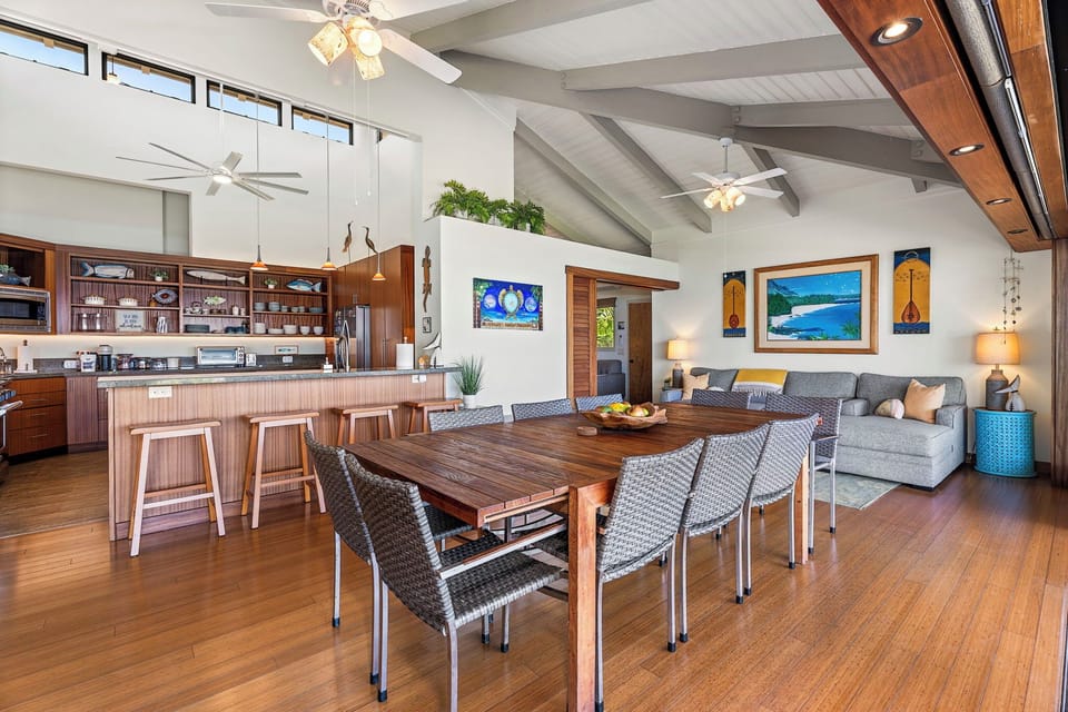 A dining table large enough for the whole group, with the open kitchen right behind it.