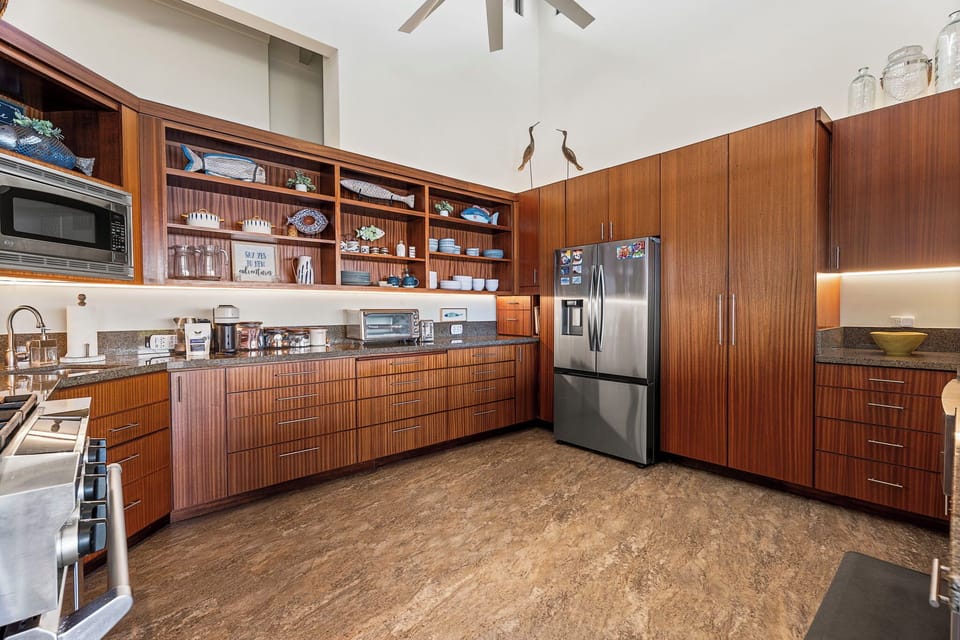 Wood cabinetry and a big fridge provide plenty of storage for cooking throughout your stay.