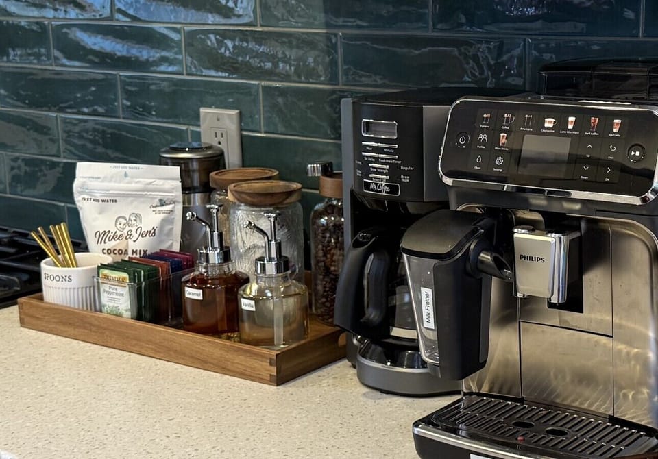 Signature coffee station: LatteGo machine crafts your custom cup - espresso, lattes, cappiccino, black coffee and more! Drip coffee machine. Local fresh coffee, Mike & Jen`s hot chocolate, assorted teas and fixings!