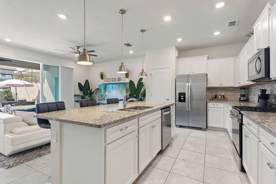 Spacious kitchen with stainless steel appliances, ample counter space, and a convenient pantry for all your essentials—perfect for extended stays and family cooking.