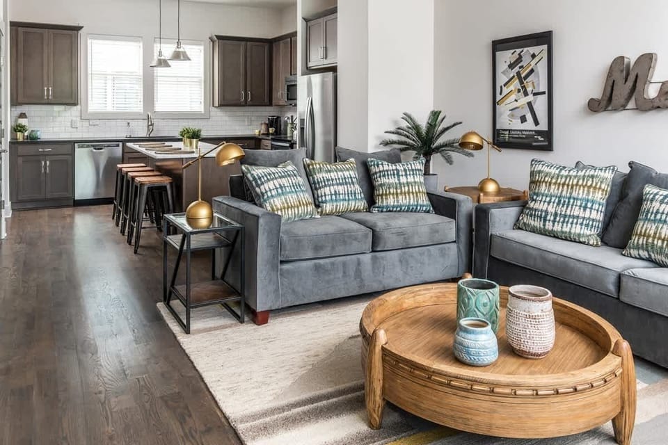 Open-concept living and kitchen with room for the whole group to spread out — plus a sofa sleeper for 2 extra guests (sleeps 9 total).
