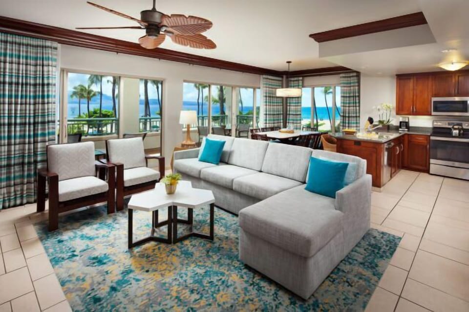 Bright coastal living room with ocean views, full kitchen, and tropical charm