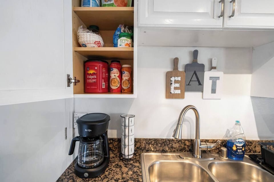 A coffee maker, supplies, and other things needed to feel at home along with ample counter space and a well-organized layout make this kitchen ideal for short stays or extended visits.
