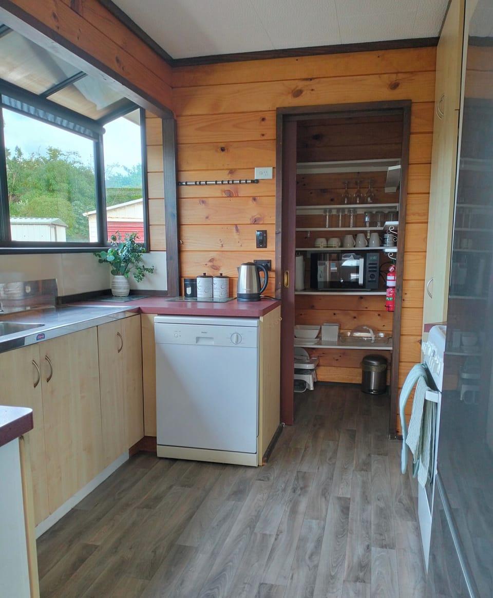 Full kitchen with oven, stove top, jug, microwave, dishwasher, rice cooker, highchair, all cutlery plates glasses and mugs (x8). filtered coffee and plunger. coffee, tea, sugar, oil, salt and pepper.