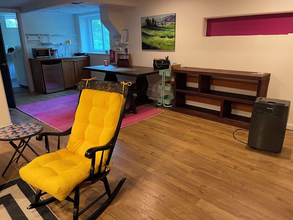 Basement with kitchenette and crafting area.