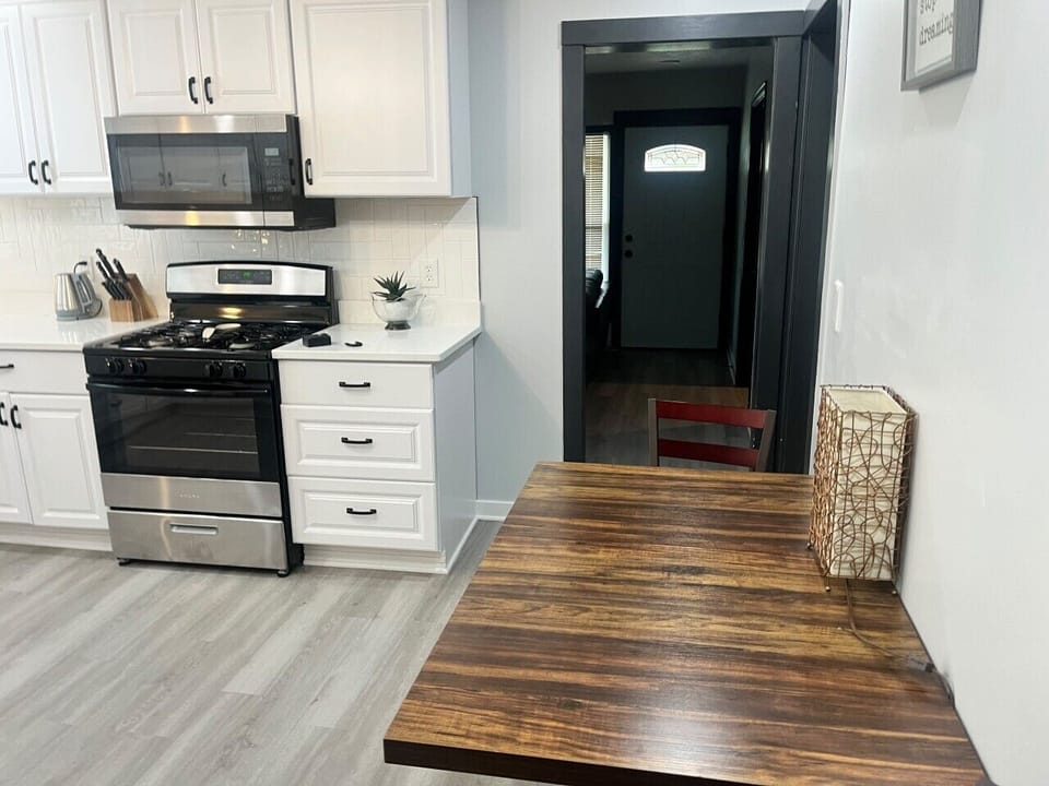 Our fully equipped, modern kitchen offers a spacious and functional layout with ample counter space and all the essential cookware needed to easily prepare home-cooked meals during your extended stay.