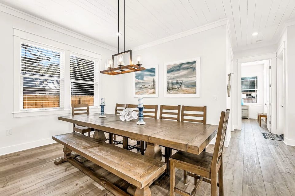 Dining Room: Gather around the large wooden dining room table with seating for up to 12 guests. The ideal space for sharing home-cooked family dinners, vacation breakfasts, and special coastal celebrations.