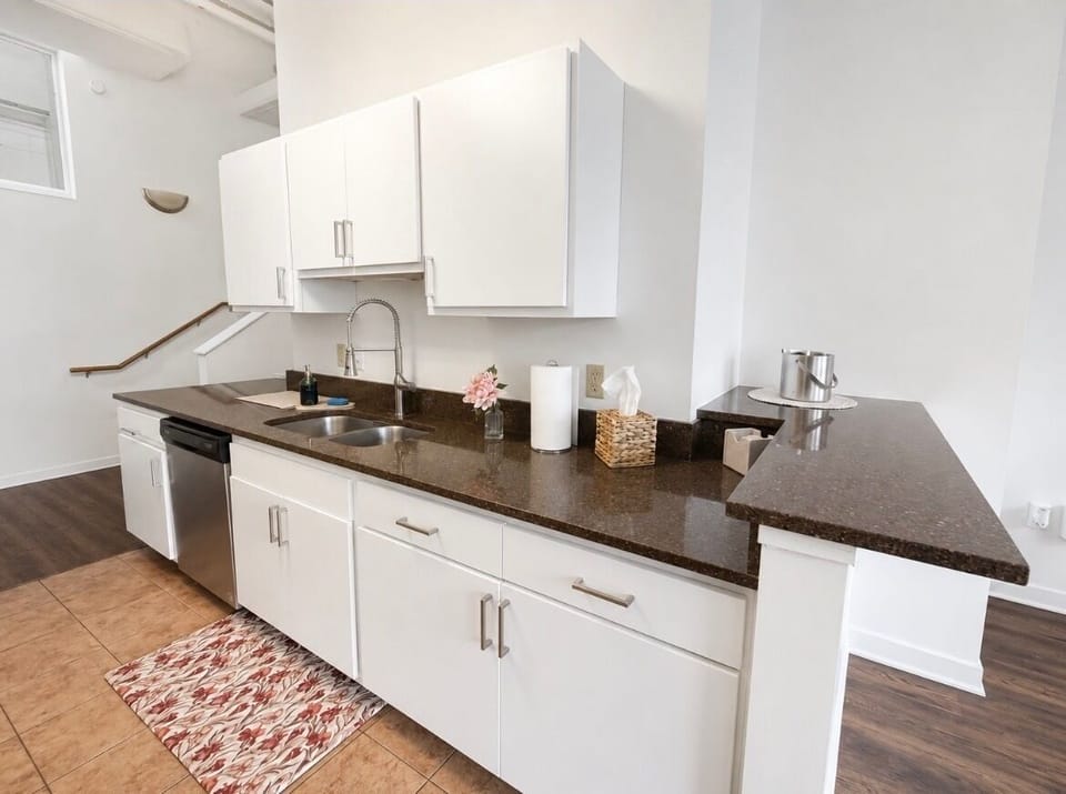 Bright modern kitchen with breakfast bar and sleek stone countertops