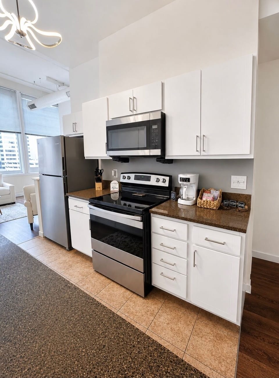 Bright modern kitchen with stainless appliances and coffee station