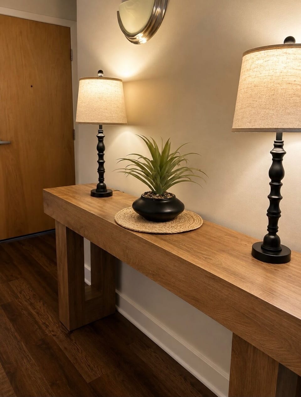 Warm, welcoming entryway with stylish console table and soft lighting